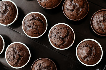 Cooking chocolate cream cupcakes. Confectioner cooks in kitchen.
