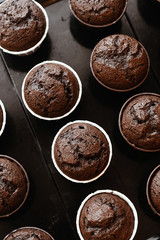 Cooking chocolate cream cupcakes. Confectioner cooks in kitchen.