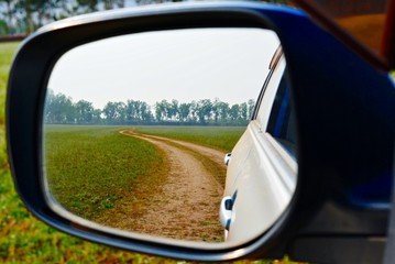 Fototapeta na wymiar Reflections in the car side mirror