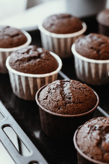 Cooking chocolate cream cupcakes. Confectioner cooks in kitchen.