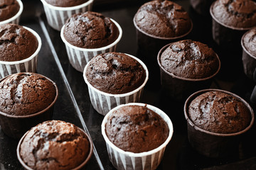 Cooking chocolate cream cupcakes. Confectioner cooks in kitchen.