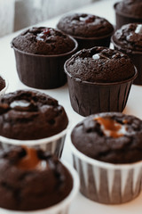 Cooking chocolate cream cupcakes. Confectioner cooks in kitchen.
