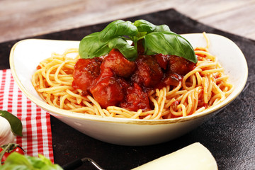 Spaghetti pasta with meatballs and tomato sauce with basil and parmesan