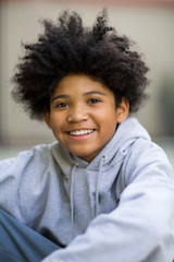 Young mixed race teenage boy looking at the camera.