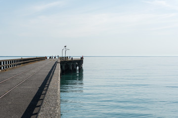 Fototapeta premium View of the end of the Tolaga Bay wharf, East Cape, New Zealand, on beautiful calm morning.
