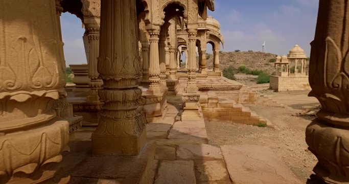 Bada bagh cenotaphs (Hindu tomb mausoleum) made of sandstone in Indian Thar desert. Jaisalmer, Rajasthan, India. Horizontal panning