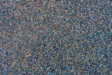 Perfect fine pebbles and shingle empty background with mixed colorful fine particles of various minerals.