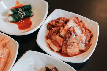 hand holding chopsticks for eating Kimchi salad in restaurant. Korean food traditional Kimchi.Korean food traditional cuisine. Fermented food. Vegetarian food good for health, Vegan for weight control