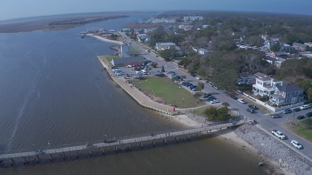 Aerial view moving toward Southport Pier in NC. The pier is in full view and then move to the shore line.