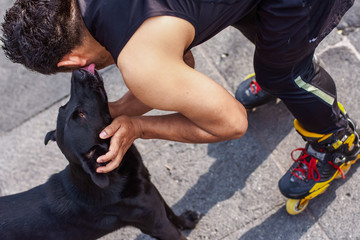 unrecognizable athletic man skating with his playful dog