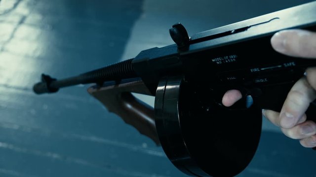 pointing a tommy machine gun