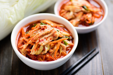 Kimchi cabbage in a bowl with chopsticks, Korean food