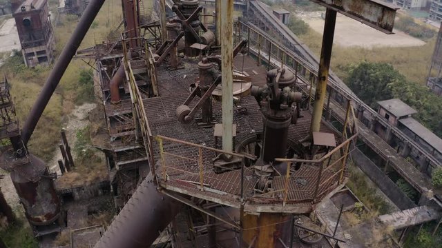 Slow descent over abandoned steel plant metal structures, Guangzhou, China, Aerial shot.