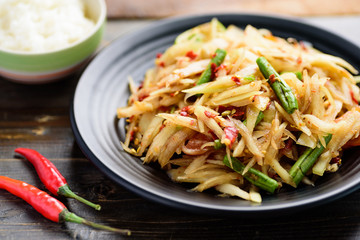 Thai food (Som Tum), spicy green papaya salad eating with sticky rice