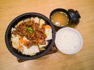 spicy grilled beef rice set close up shot on a wooden table.