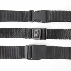 black plastic Fastex clip for backpacks on a white background. items of clothing and equipment