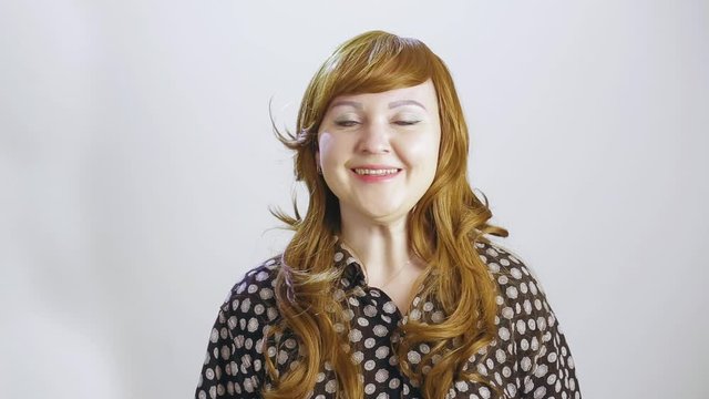 Young woman sneezes on a white background