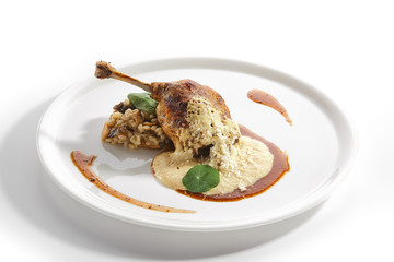 Duck Leg Confit with Pearl Barley on Restaurant Plate Isolated