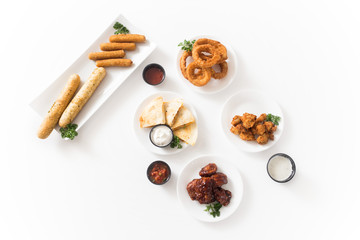 Buffalo wings, onion rings, quesadillas, mozzarella sticks, breadsticks, and chicken nugget appetizer spread