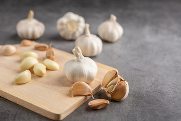 Garlic on the black cement floor. High angle view.