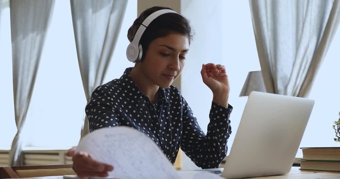 Indian girl internet teacher wear headphones teach online by webcam