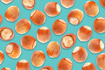 Colorful pattern of hazelnuts on blue background. Top view. Chocolate packaging cover