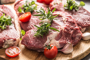 Beef ribe eye steaks with rosemary oregano and tomatoes