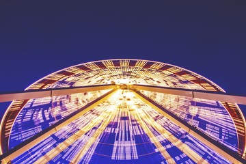 Low angle shot of a Ferris wheel on Chicago Navy Pier during the evening time