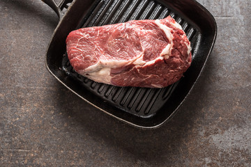 Raw Beef ribe eye steak in grill pan - Top of view