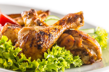 Roasted chicken legs with lettuce salad and tomatoes