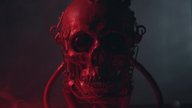 Robotic skull in red light with smoke