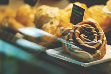 Traditional Swedish cinnamon buns. A very popular snack throughout Scandinavia known as Fika. Closeup of delicious freshly baked cinnamon bun in showcase