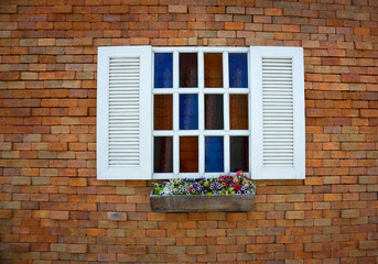 Fototapeta na wymiar colorful white window on a brick wall.