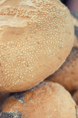 Fresh baked loaves of rye or wheat bread with sesame seeds