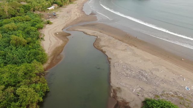 Aerial view of river running to the beach and ocean