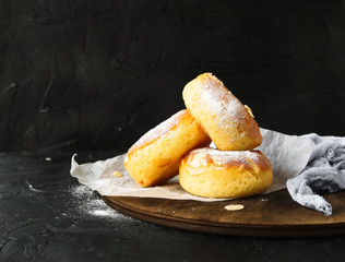 Almond flakes donuts on a black background with space for text. 