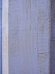 Fototapeta premium Vertical: Historic building stones with textured, artistically designed patterns.