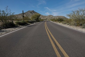 A paved road curves through the desert