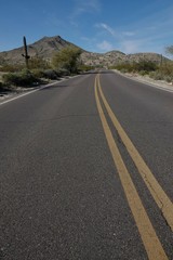 A paved road curves through the desert