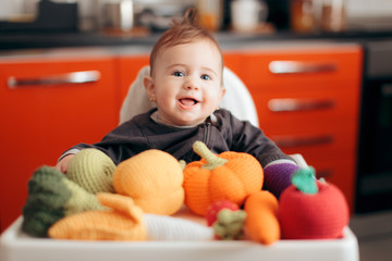 Funny Baby with Knitted Vegetables Starting Food Diversification 