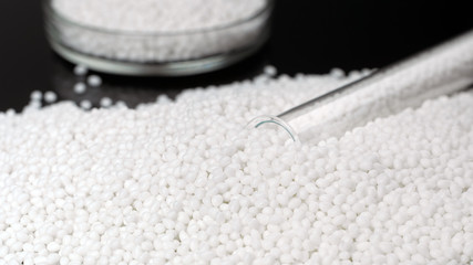 Closeup white granules of plastic polymer