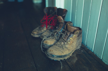 Two. pair of muddy boots in entrance