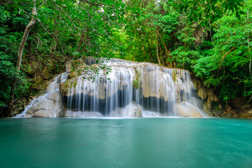 Fototapeta na wymiar Waterfall in Tropical forest at Erawan waterfall National Park, Thailand