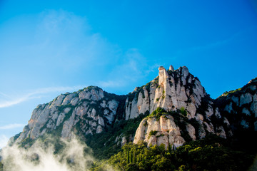 BARCELONA, SPAIN - December 26, 2018: The mountains and buildings of Montserrat in Barcelona, Spain. Montserrat  is a Spanish shaped mountain which influenced Antoni Gaudi to make his art works.