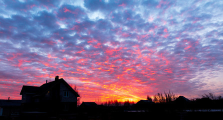 Clouds at dawn of the sun in the village
