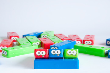 Children's plastic designer multicolored folded on top of each other. Artificial eyes. On white background