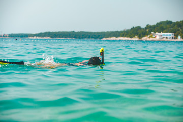 woman in snorkeling mask in sea water