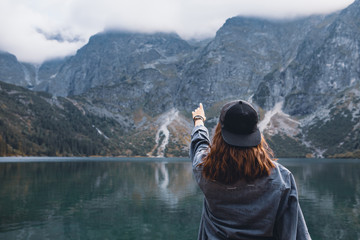 woman trying reach out the sky landscape view of lake at mountains