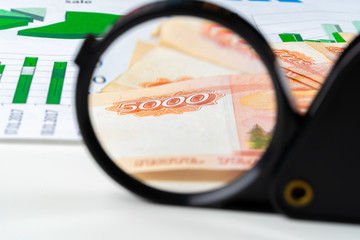 Magnifying Glass on the Russian Currency Rubles