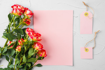 Top view of a pink paper letter and flowers with copy space